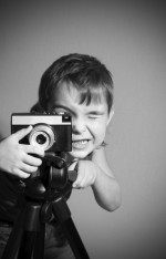 a kid clicking pictures with a black camera